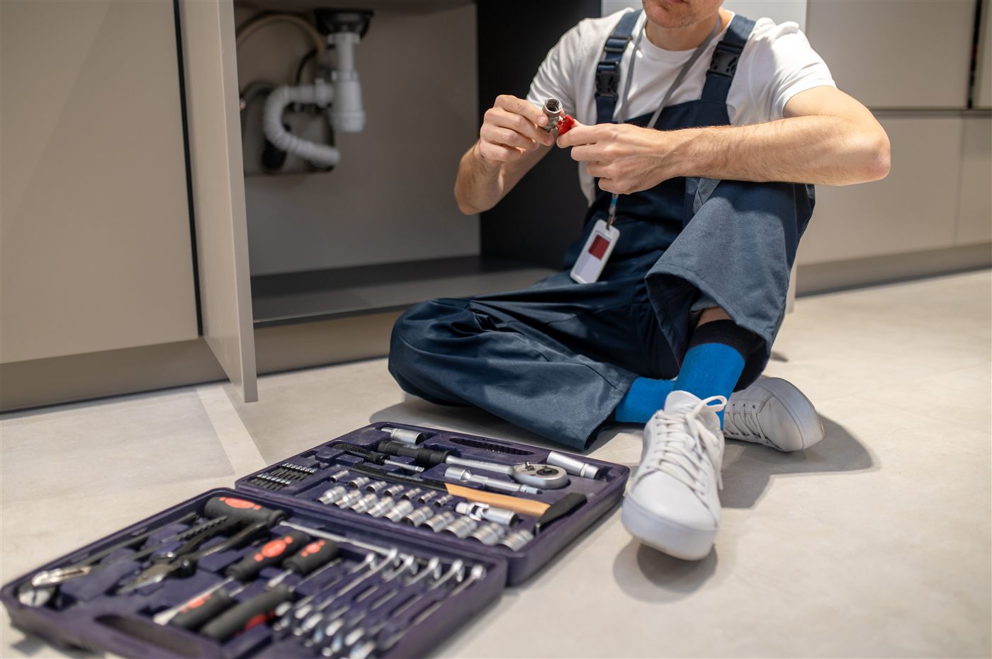 Plumber installing drain assembly for construction plumbing
